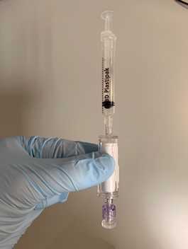 Figure 3. Adding sample preservative to the filter unit. Figure 3. Adding sample preservative to the filter unit.